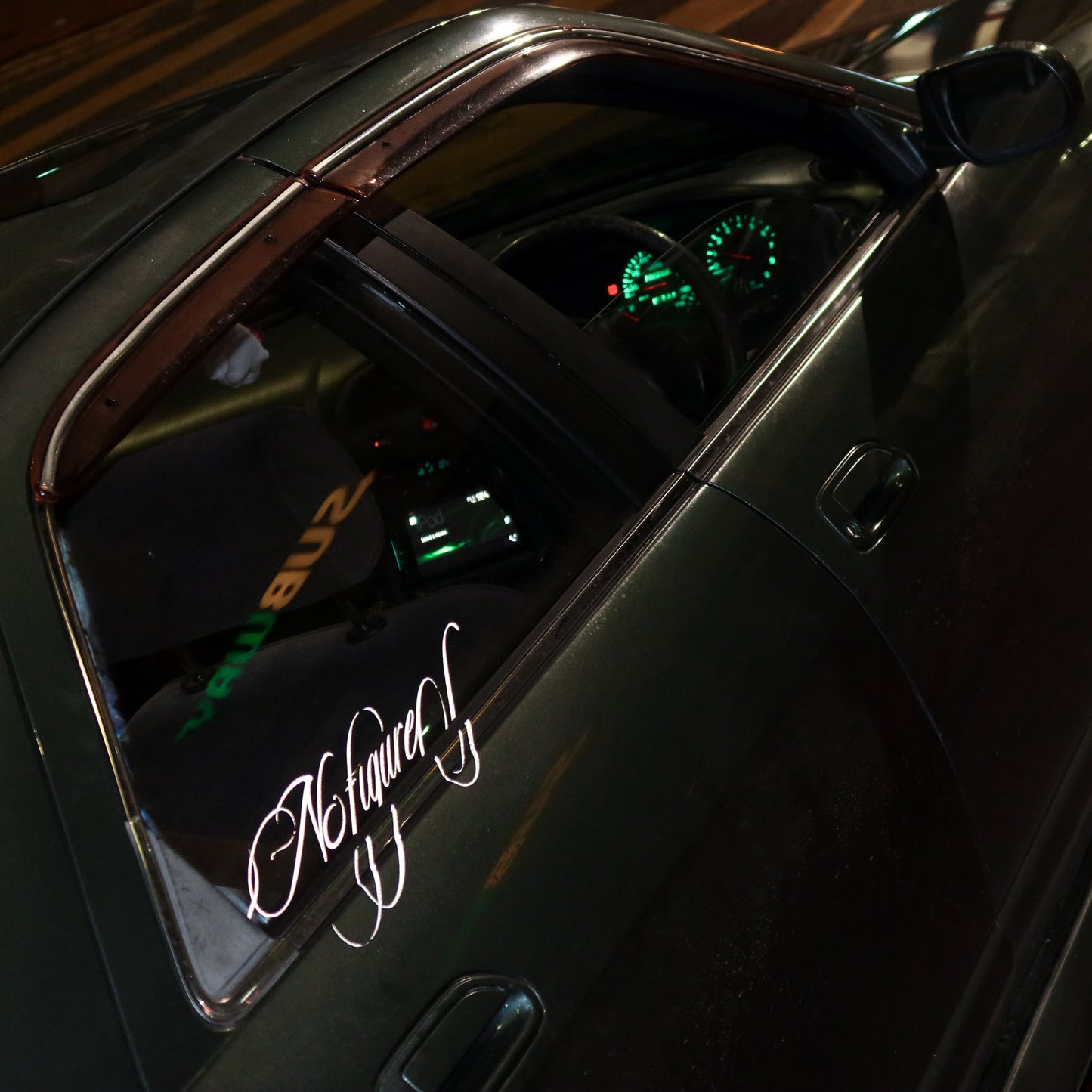 Close-up of a car's interior with a visible brand logo on a dark background