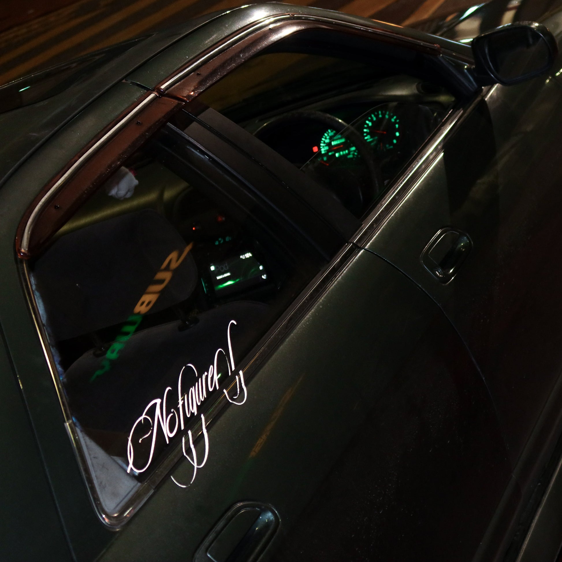 Close-up of a car's interior with a visible brand logo on a dark background